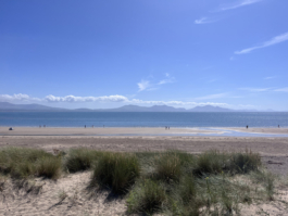 sand dunes, looking out towards the sea and mountains in the distance Ross Woodhall - Action & Lifestyle Photography