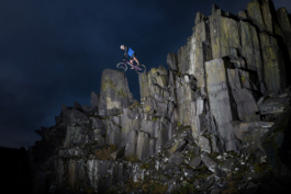 Biker on top of a slate wall. Ross Woodhall - Action & Lifestyle Photography