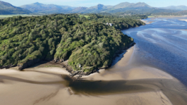 drone shoot of Portmeirion. tide out with sand showing and woods. Ross Woodhall - Action & Lifestyle Photography