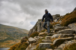 Hiker walking down some steps on a hill side with lake in distance Ross Woodhall - Action & Lifestyle Photography