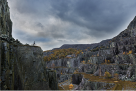 Cliff with valley, with 2 mountain bikers Ross Woodhall - Action & Lifestyle Photography