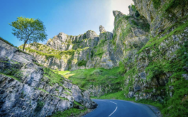 gorge with steep side and greenery with a road through it Ross Woodhall - Action & Lifestyle Photography